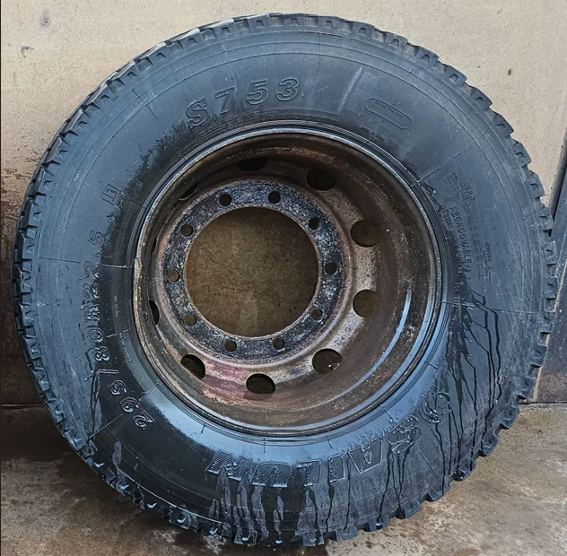 Worn truck rim before professional surface restoration